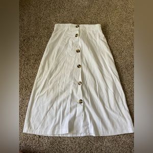 White skirt with buttons.